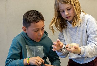 Workshop Schiffsbau TITANIC - 2 Kinder bohren Loch in Rohling - Ausstellungszentrum Lokschuppen Rosenheim © Axel Jusseit Workshop Schiffsbau TITANIC - 2 Kinder bohren Loch in Rohling - Ausstellungszentrum Lokschuppen Rosenheim © Axel Jusseit